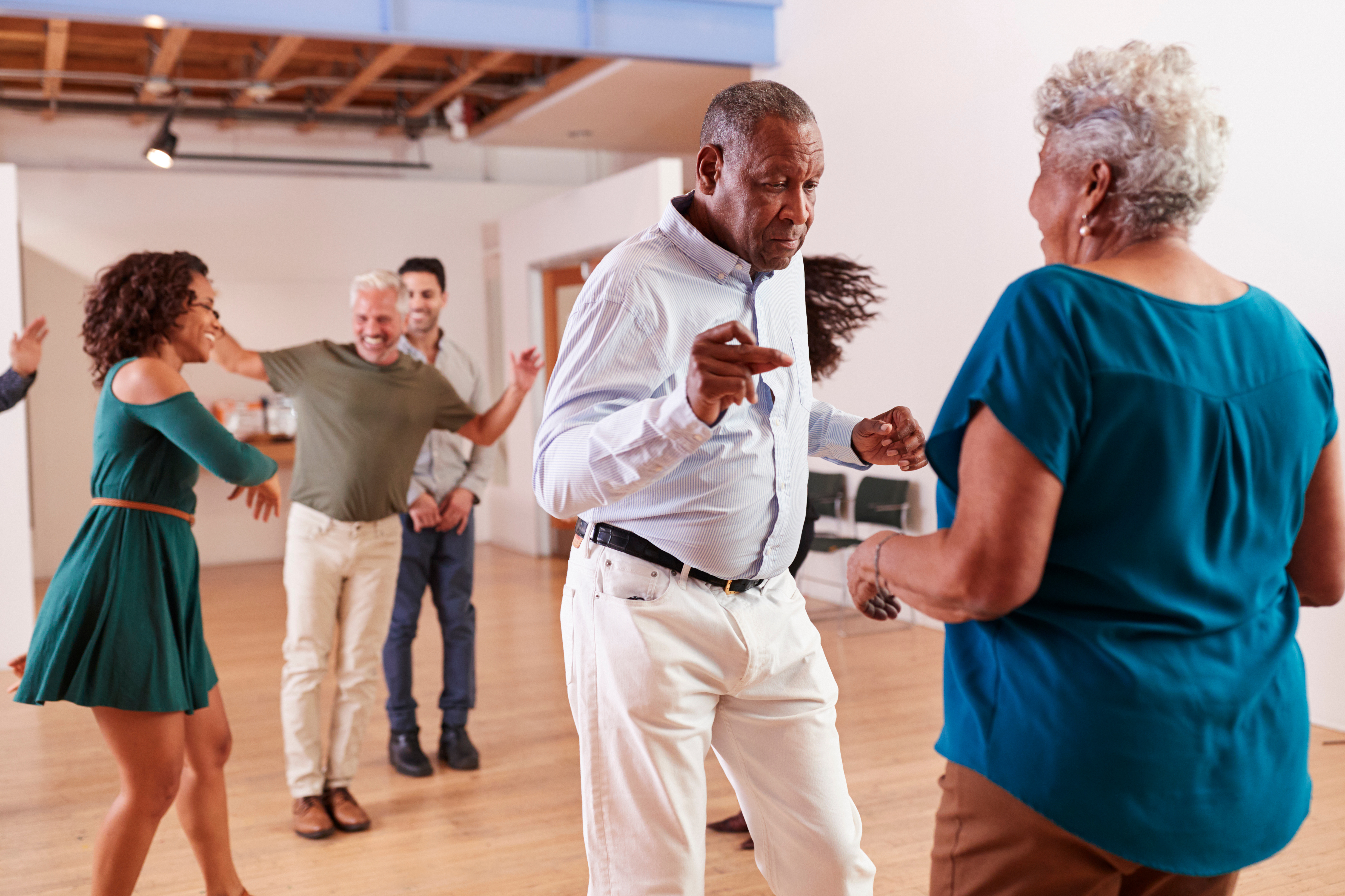 Dance instructor leading a lively group class